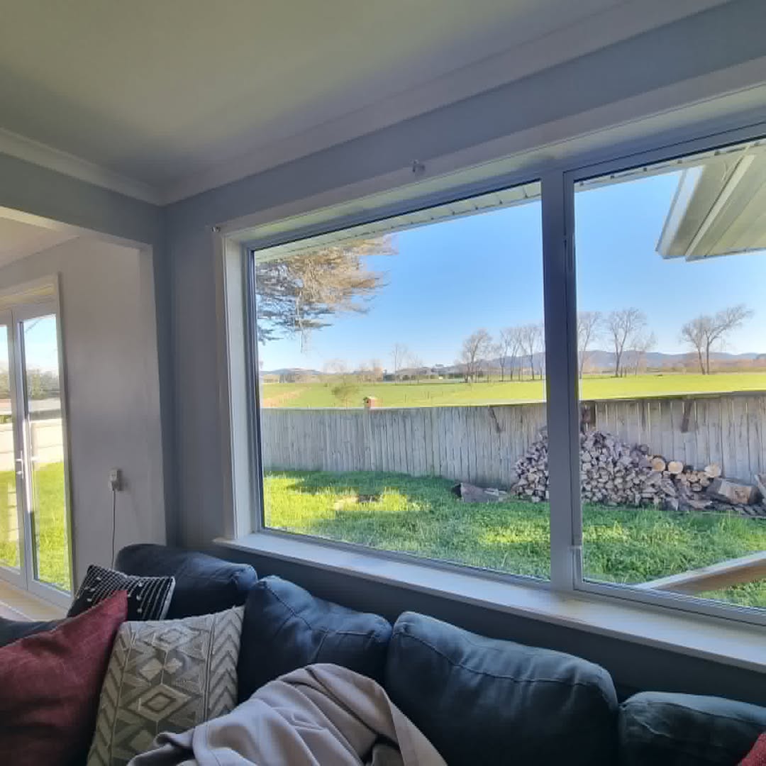 Living room with a wide aluminium picture window over the garden
